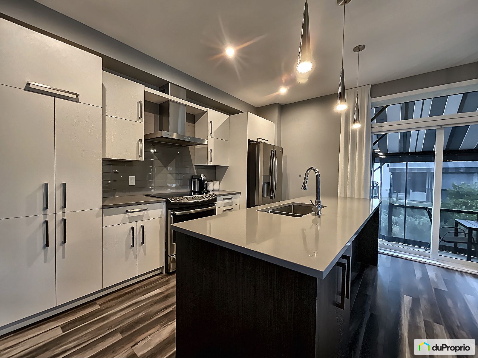 Modern Kitchen at Terrebonne  Quartz counters, laminate cabinets